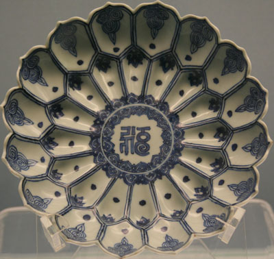 Blue and white porcelain plate with lotus petal design and Sanskrit text